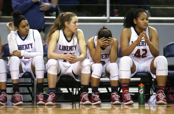 Liberty players watch the action during the NIAA Division I state basketball championship ga ...