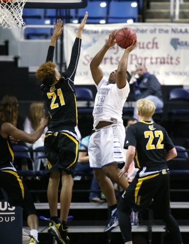 Desert Pines‘ Jalen Graves shoots over Clark defender Jalen Hill during the NIAA Divis ...