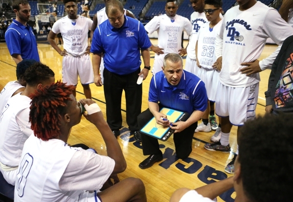 Desert Pines Head Coach Mike Uzan talks to his team during a timeout in the NIAA Division I- ...