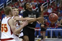 Word of Life‘s Trent McCall gets fouled by Whittell‘s Palmer Chaplin, center, du ...
