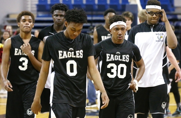 Word of Life players leave the court after losing the NIAA Division IV state basketball cham ...