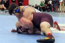 Ryan Vanario of Boulder City, top, grapples with Jeremy Albertson of Pahrump Valley in a qua ...