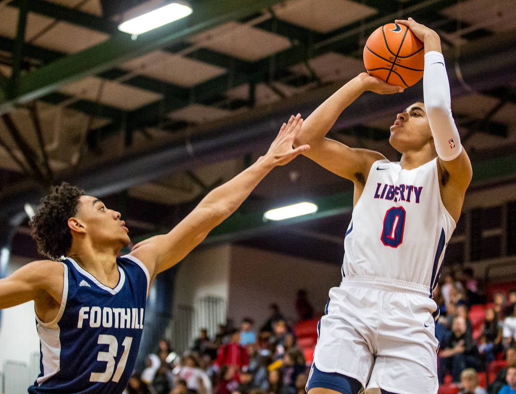 Liberty’s Julian Strawther (0) goes up for a shot while Foothill’s Marvin Colema ...