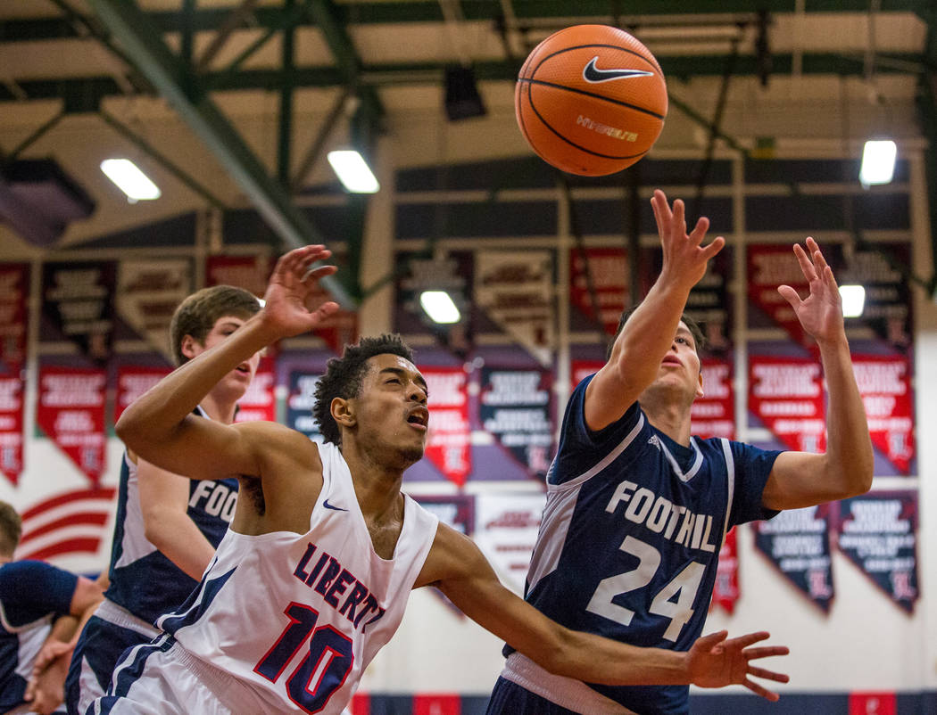 Liberty’s Jordan Holt (10) and Foothill’s Anthony Martin (24) grapple over the b ...