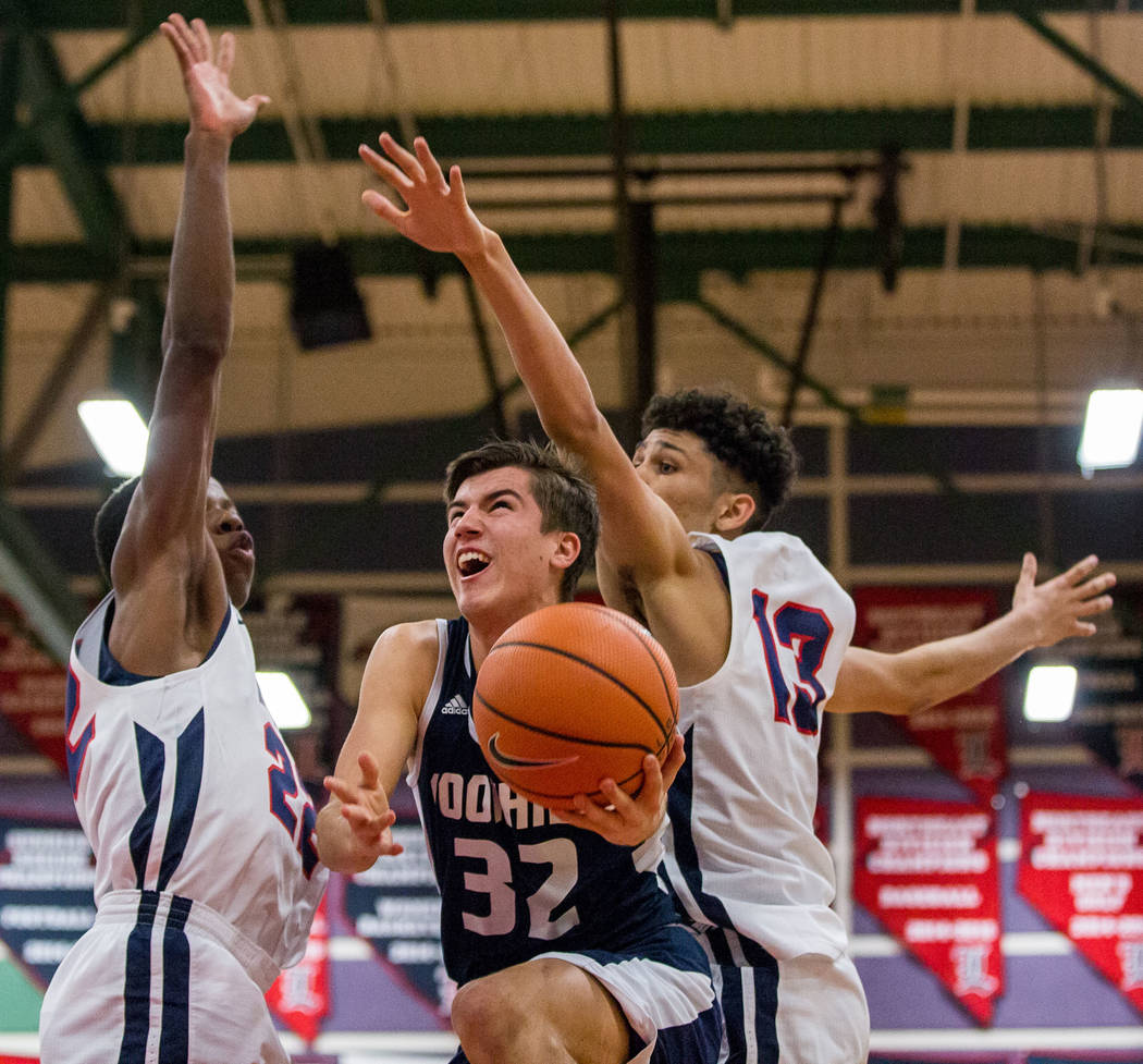 Foothill’s Dylan Hushaw (32) looks for a shot while Liberty defenders Jordan Wafer (22 ...