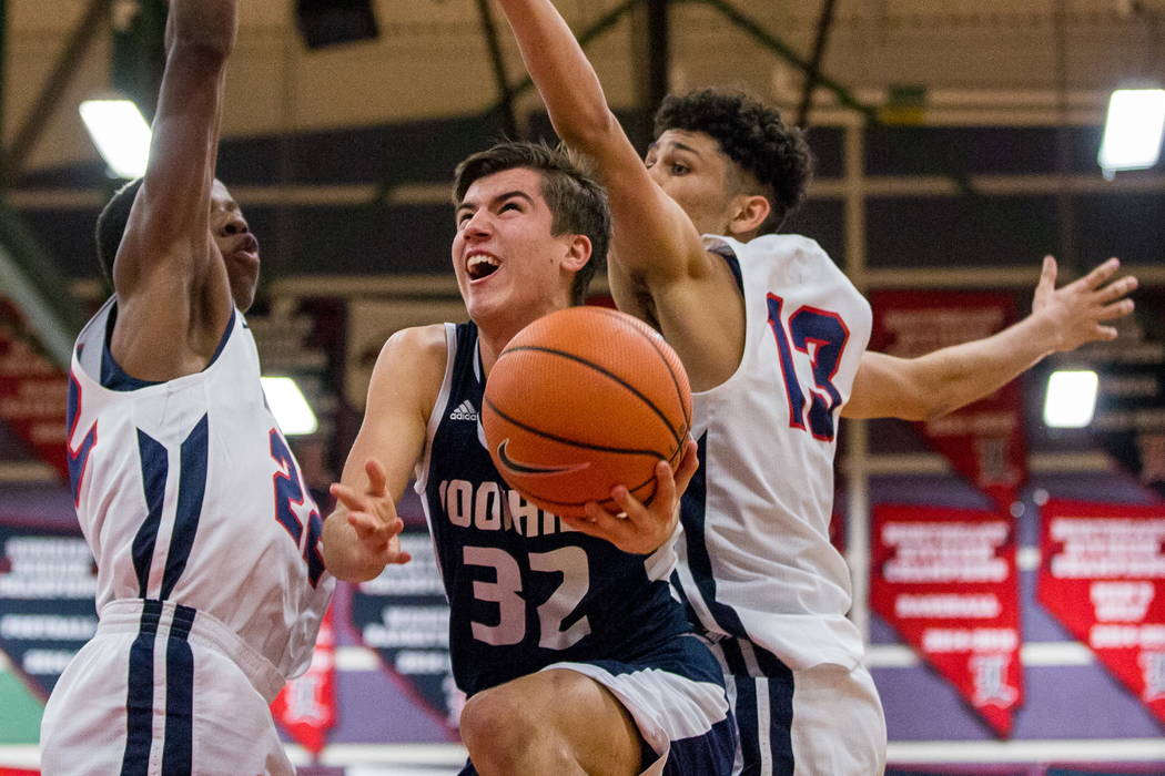 Foothill’s Dylan Hushaw (32) looks for a shot while Liberty defenders Jordan Wafer (22 ...