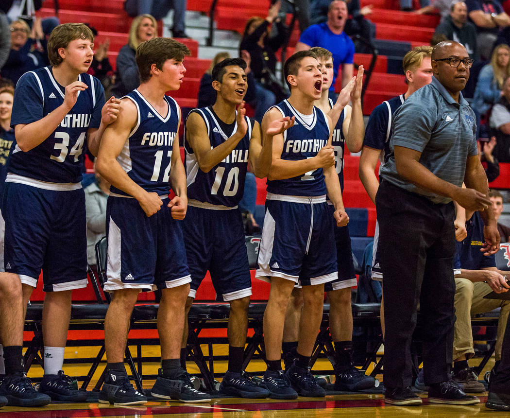 Foothill players cheer from the bench as their team makes progress in a close game against L ...
