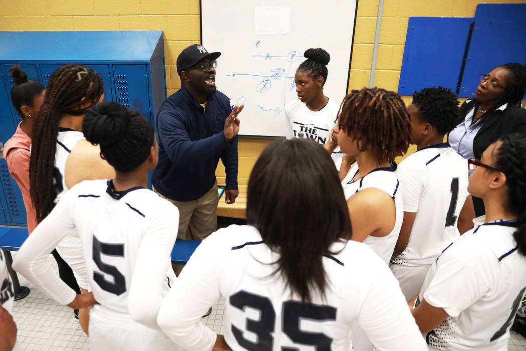 Cheyenne High’s coach Clifton Lott talks to his team during a basketball game against ...