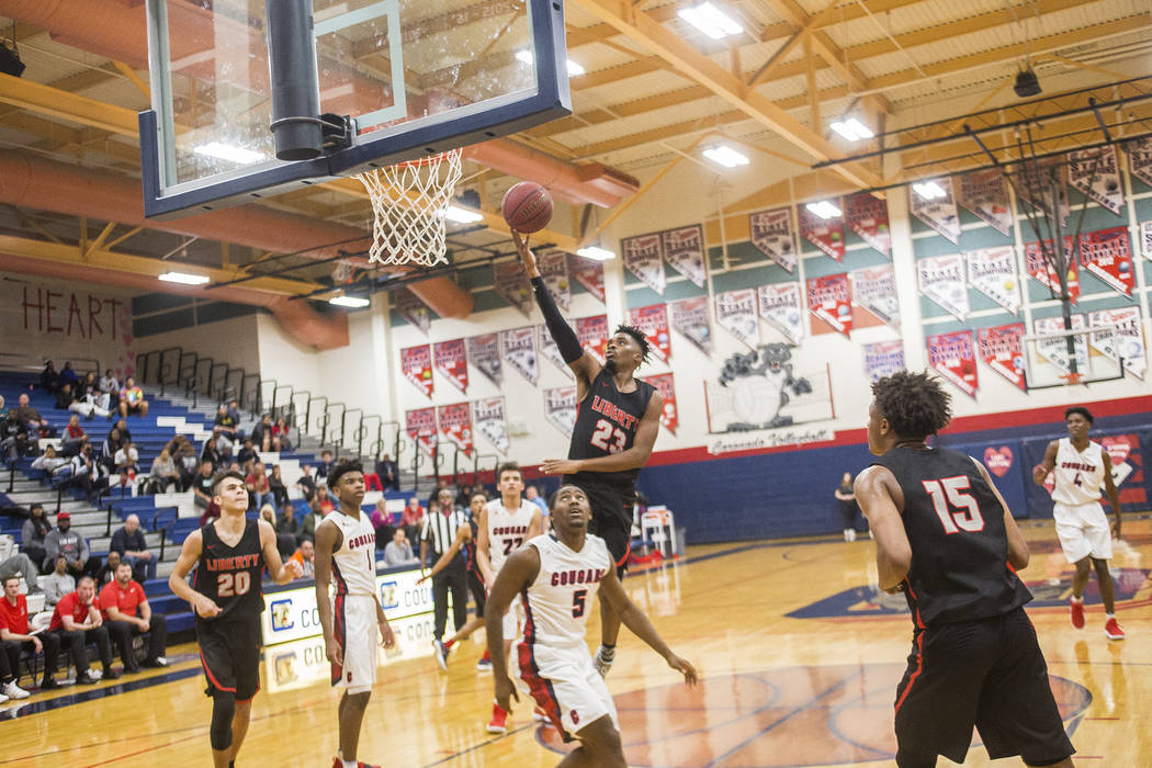 Liberty High School’s Davion Ware (23) attempts a basket in a game against Coronado Hi ...