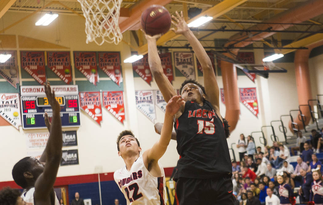 Liberty High School’s Cameron Burist (15) attempts a basket against Coronado High Scho ...
