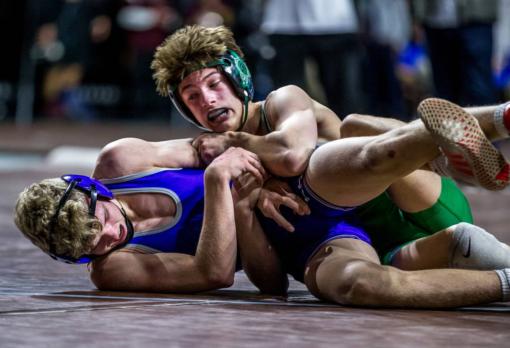 William Zernich of Green Valley attempts to pin down Owen Jones of Spanish Springs while wre ...
