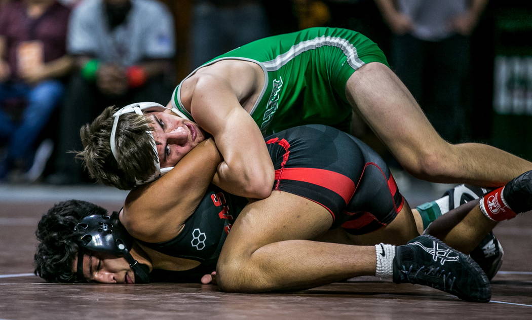 Justus Scott of Green Valley, top, and Jakob Alvarado of Las Vegas wrestle in the 4A 152 pou ...