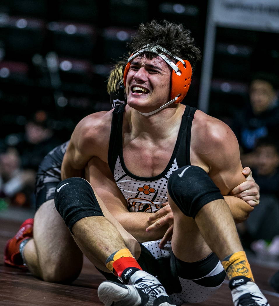 Blake Murray of Douglas struggles against Connor Bourne of Faith Lutheran while wrestling in ...