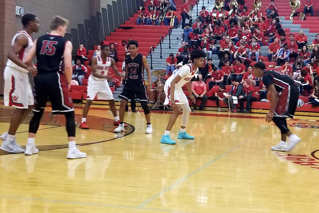 Desert Oasis’ Kamari Burnside, right, dribbles against Arbor View’s Donovan Yap ...