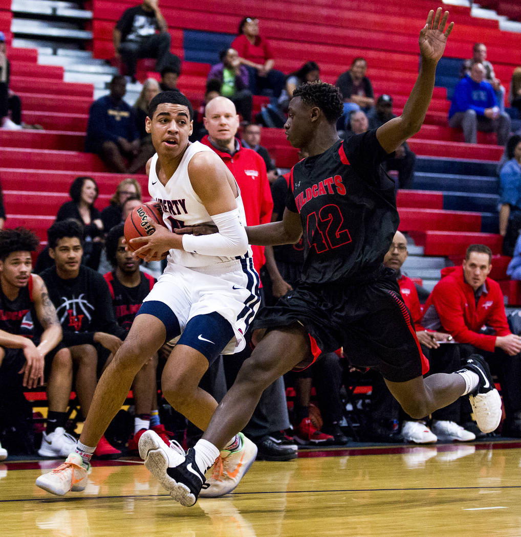 Liberty’s Julian Strawther (0) tries to keep the ball away from Las Vegas’ Miles ...