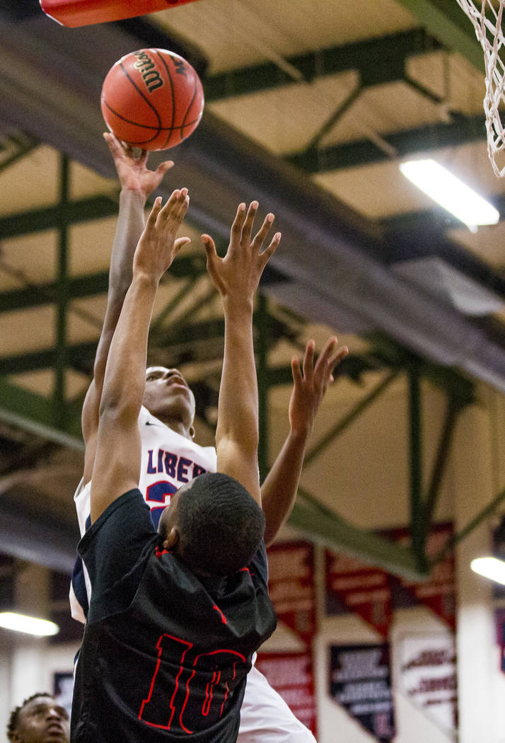 Liberty’s Jordan Wafer (22) goes up for a shot while Las Vegas’ Rashaan Shepherd ...