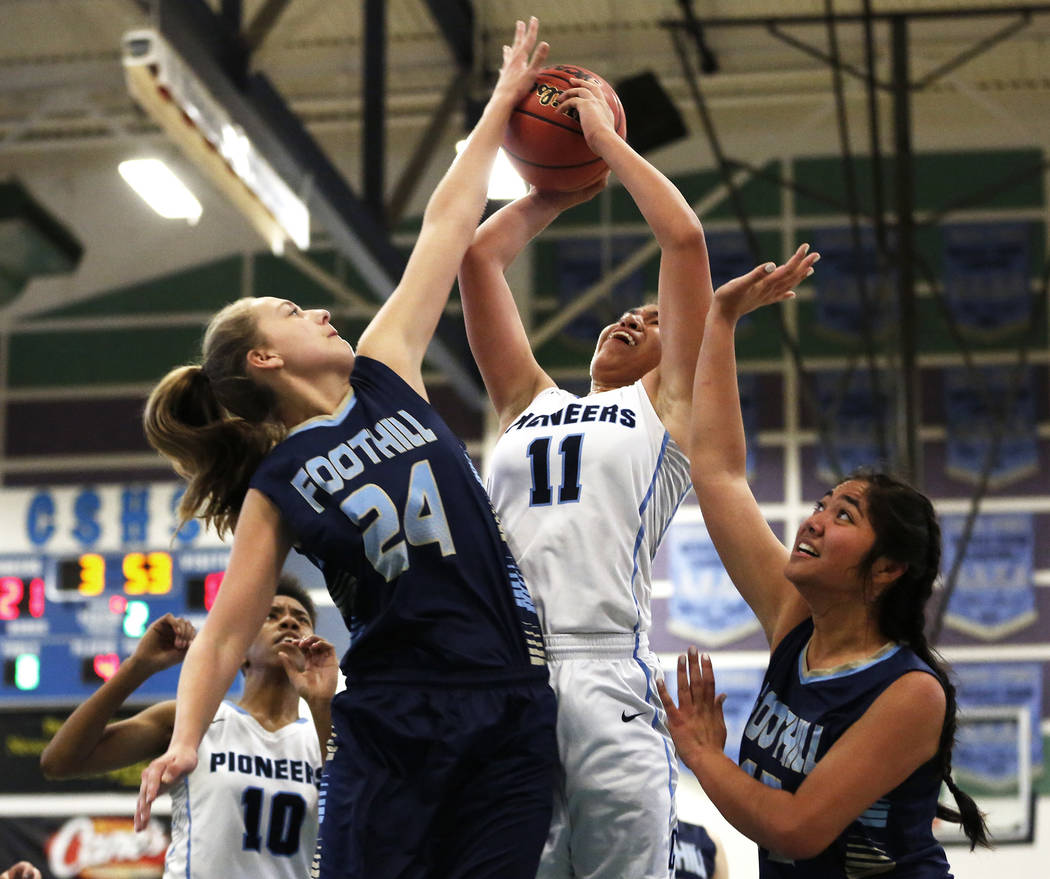 Canyon Springs’ Jeanette Fine (11) tries to shoot against Foothill’s Laurel Rock ...