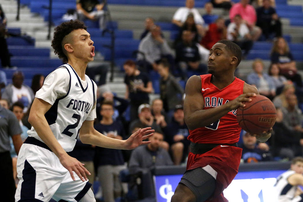 Coronado’s Eric Alston (5) shoots against Foothill’s Jace Roquemore (22) during ...