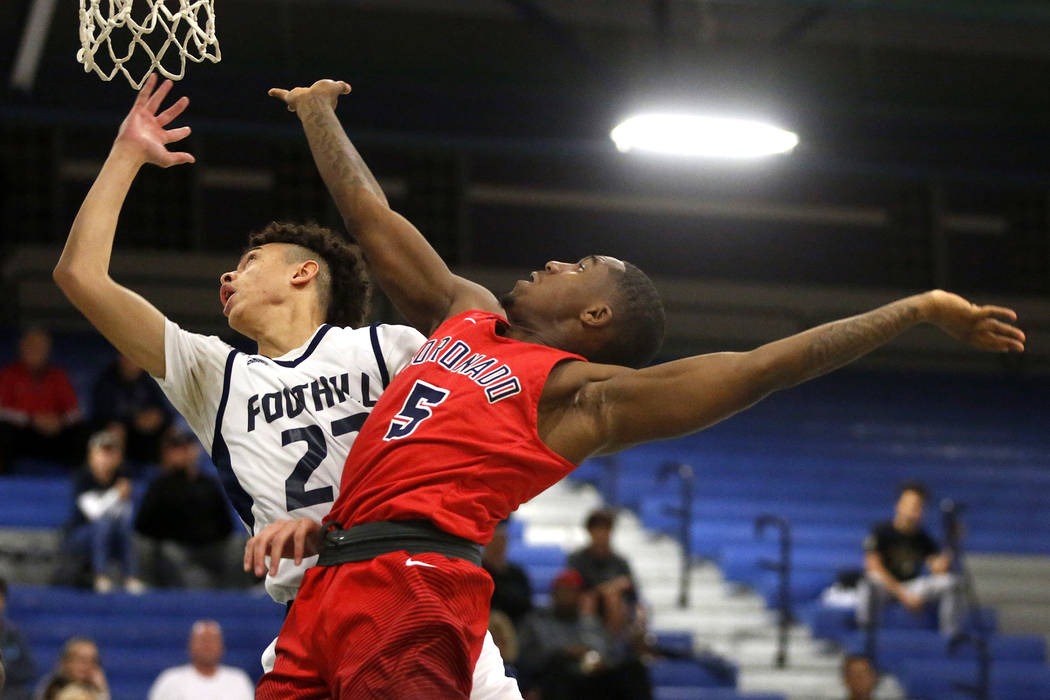 Coronado’s Eric Alston (5) shoots against Foothill’s Jace Roquemore (22) during ...