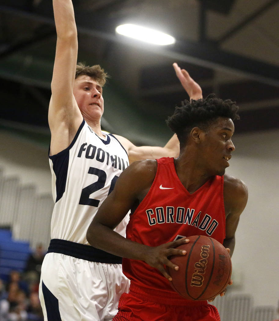Foothill’s Caleb Stearman (20) defends against Coronado’s Tahj Comeaux (4) durin ...