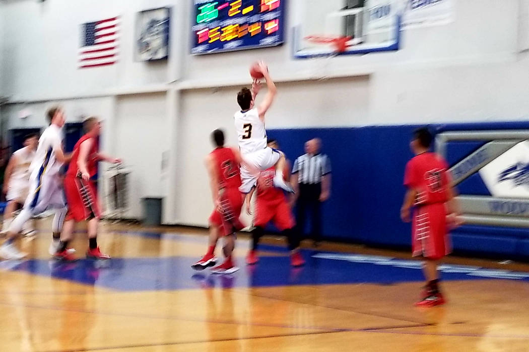 Pahranagat Valley’s Richard Lewis takes the ball to the basket against Sandy Valley on ...