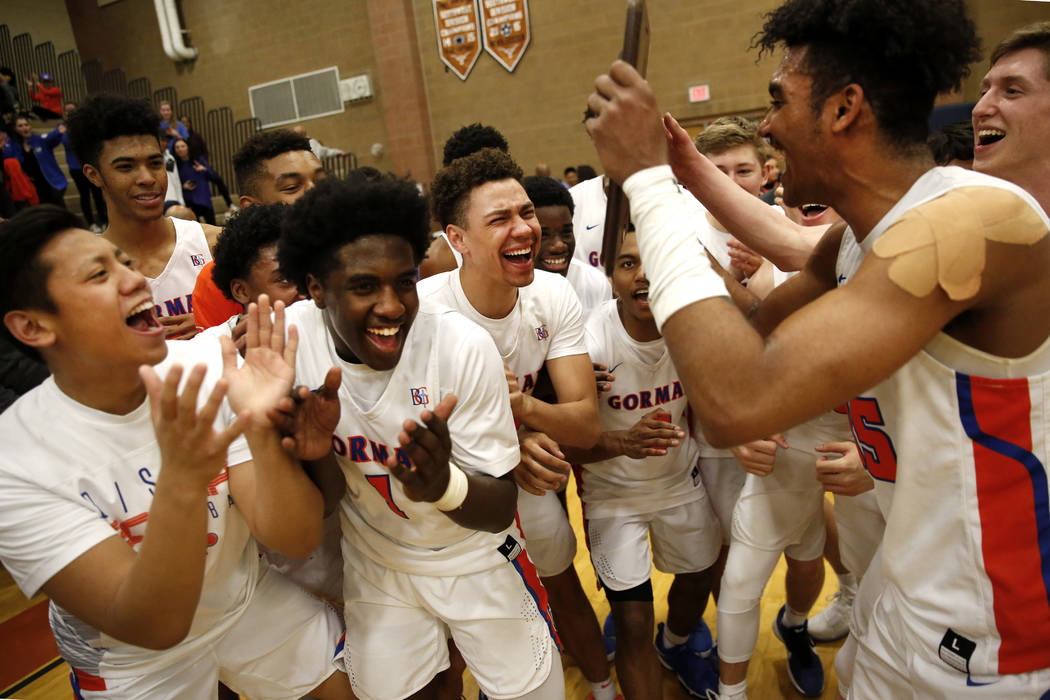 Bishop Gorman boys basketball team celebrates after beating Clark in the Sunset Region boys ...