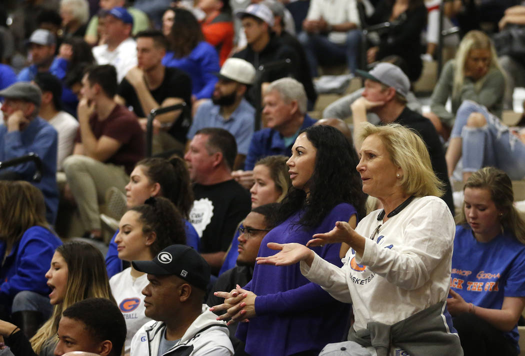 Fans react during the Sunset Region boys basketball championship at Legacy High School in No ...