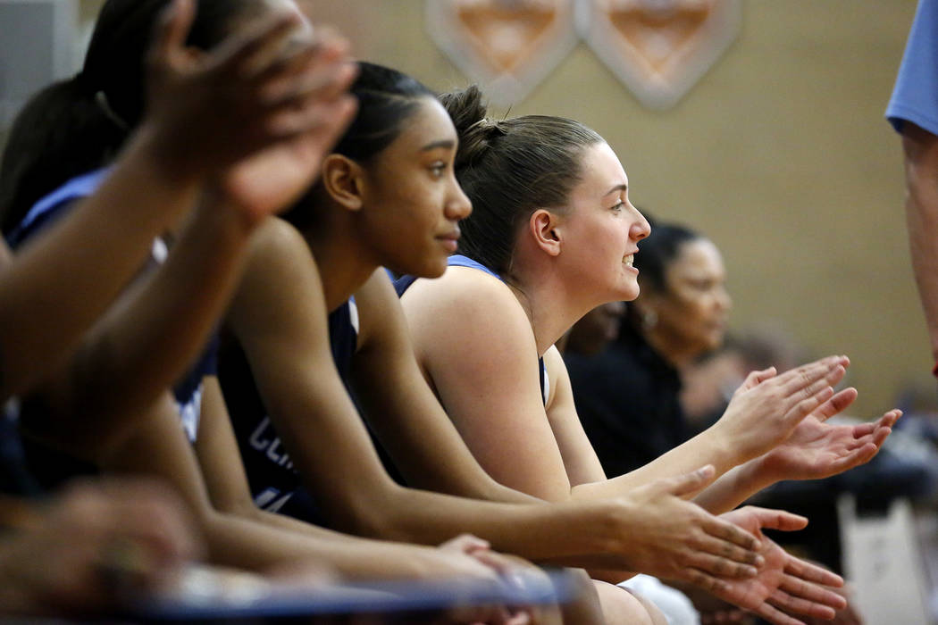 The Centennial girls basketball team cheers for their teammates after a play during the Suns ...