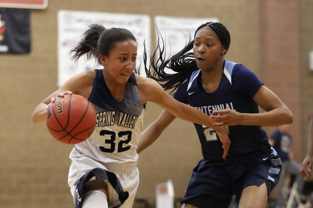 Spring Valley’s Garrisen Freeman (32) dribbles around Centennial’s Taylor Bigby ...