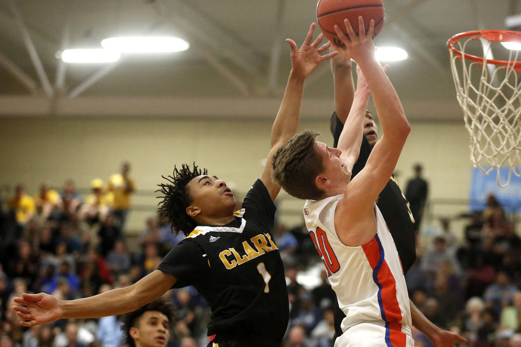 Bishop Gorman’s Noah Taitz (20) shoots against Clark’s Frankie Collins (1) duri ...