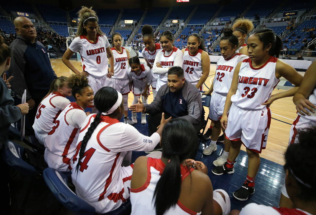 Liberty’s head coach Chad Kapanui talks to his team during the NIAA state basketball t ...
