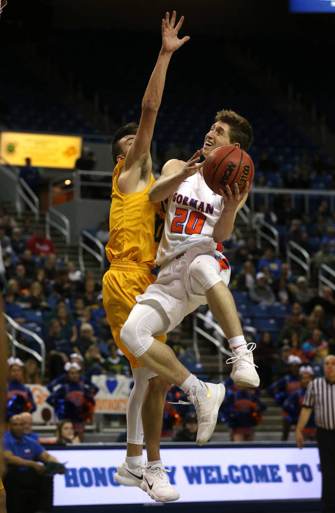 Bishop Gorman’s Noah Taitz shoots over a Bishop Manogue defender in the 4A NIAA state ...