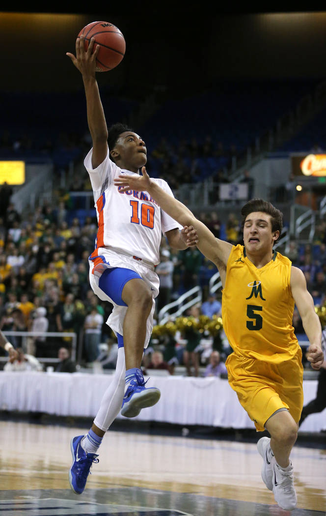Bishop Gorman’s Zaon Collins shoots over Bishop Manogue defender Mateo Reviglio durin ...