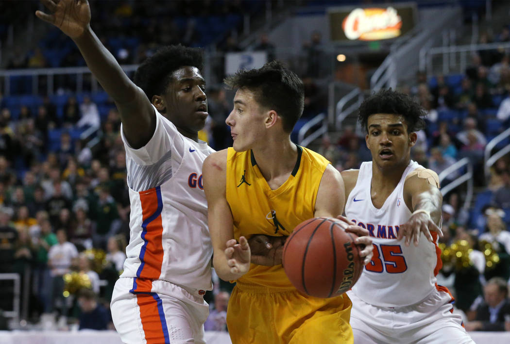Bishop Gorman defenders William McClendon, left, and Jamal Bey pressure Bishop Manogue&#8217 ...