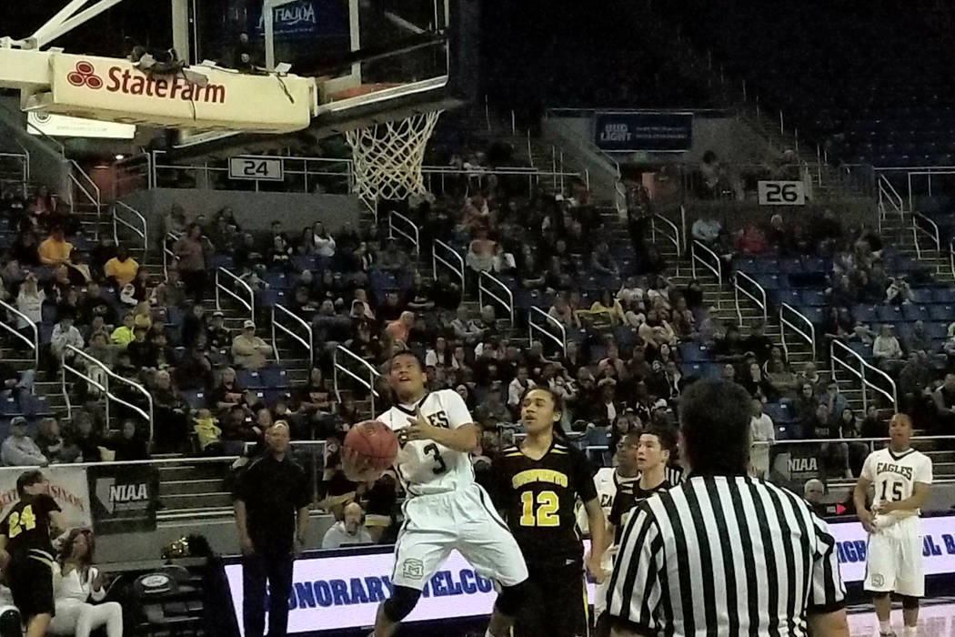 Spring Mountain’s Jeremiah Jimenez drives past Mineral County’s Robert McFalls o ...