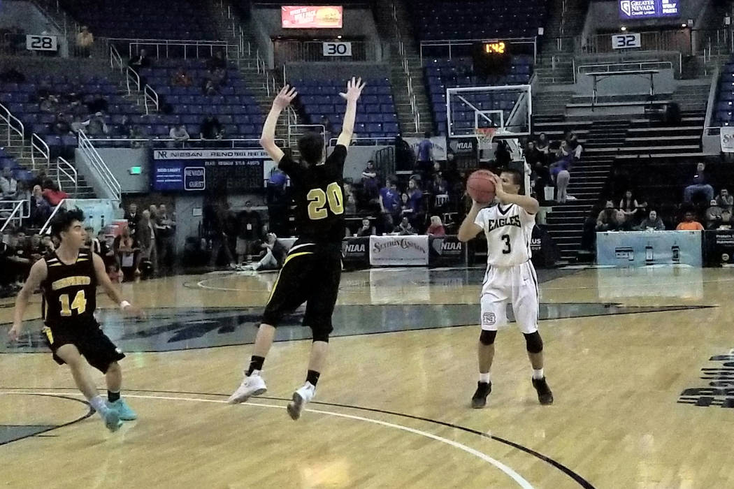 Spring Mountain’s Jeremiah Jimenez shoots over Mineral County’s Victor Montoya o ...