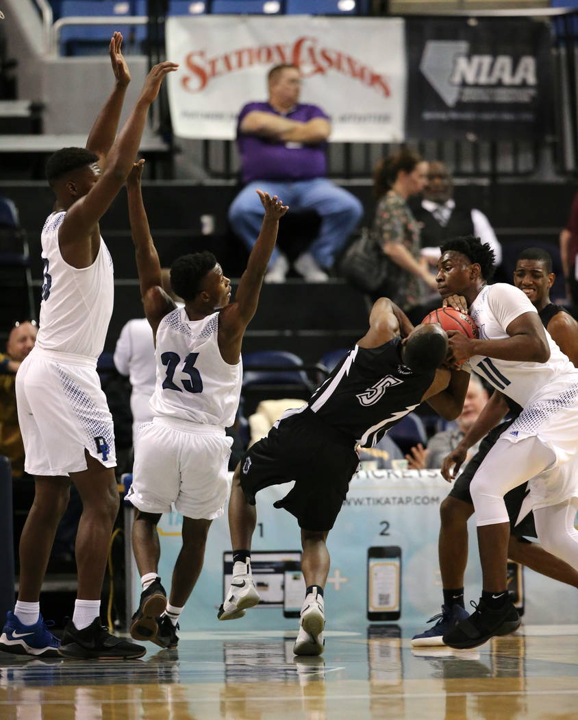 Desert Pines defender Darius Mitchell, right, gets called for a foul in a play with Cheyenne ...