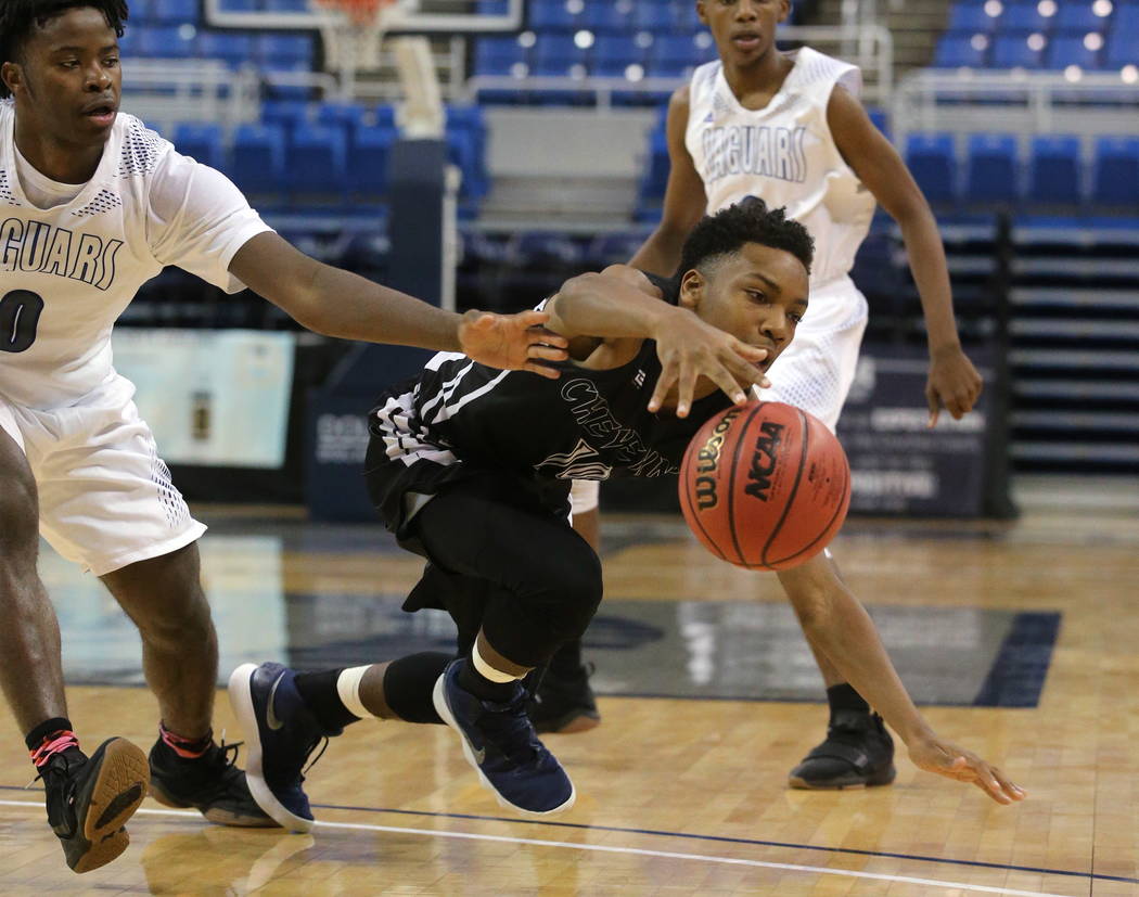 Cheyenne’s Jermaine McCormick fights for a loose ball with Desert Pines’ Hasani ...