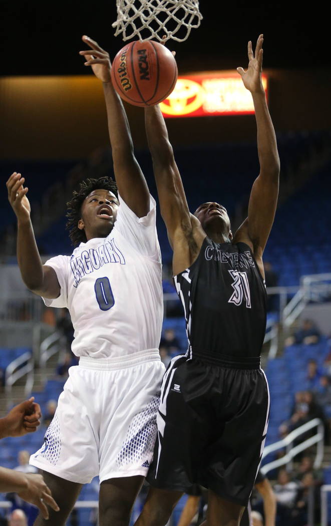 Desert Pines’ Hasani Jameel and Cheyenne’s Hahsonie Laushaul fight for a loose b ...