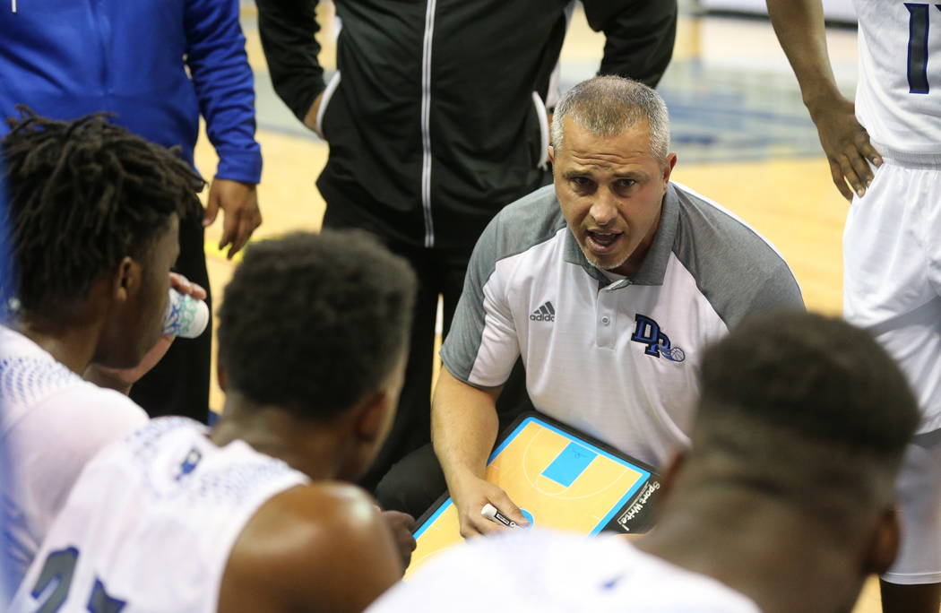 Desert Pines head coach talks to the team during a time out in the NIAA 3A state basketball ...