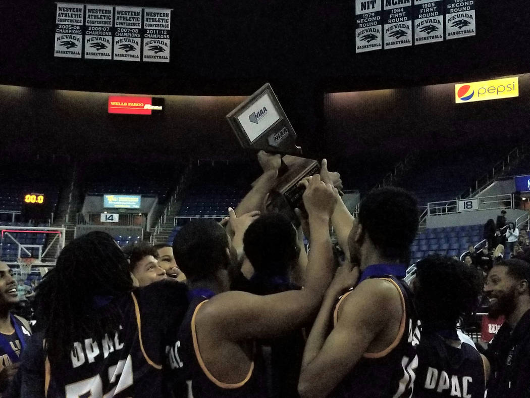 Democracy Prep players celebrate after beating Battle Mountain 72-48 for the Class 2A boys s ...