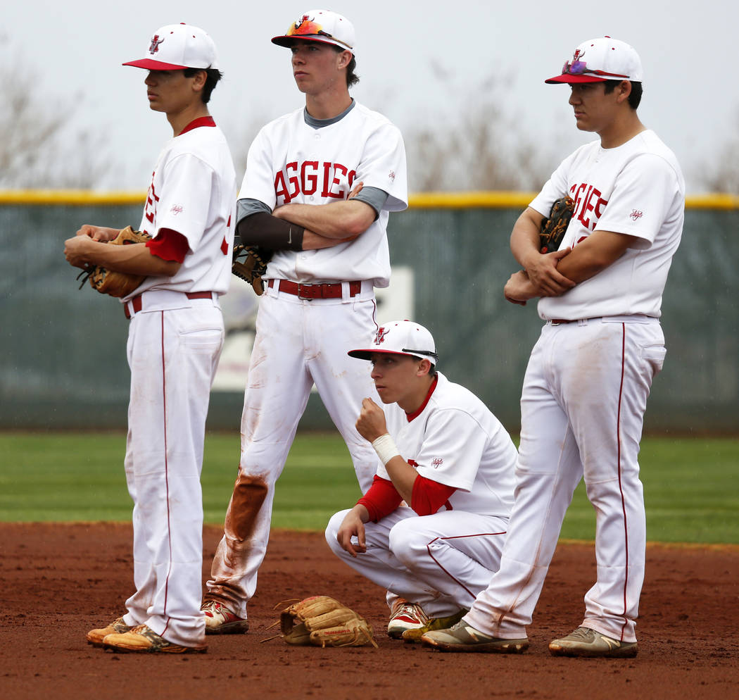 Arbor View Aggies wait at second base during a mound visit against the Rancho Rams at Desert ...