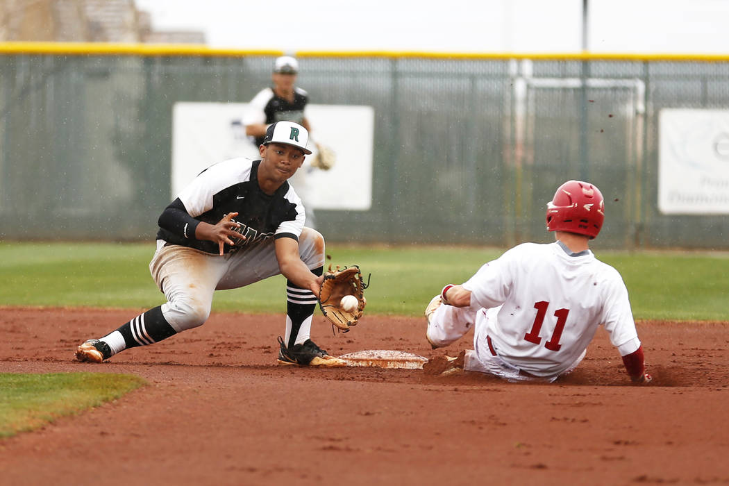 Arbor View Aggies’ Tyler Whitaker (11) steals second base before Rancho Rams’ Ed ...