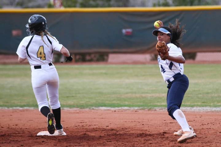 Centennial’s Kiana Tate (4) throws to first base after getting out Faith Lutheran&#821 ...