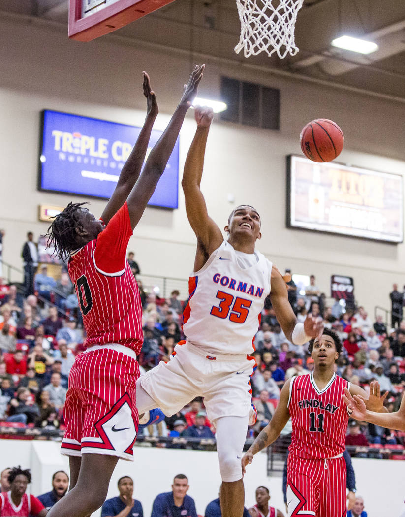 Bishop Gorman’s Jamal Bey (35) loses control of the ball against Findlay Prep’s ...