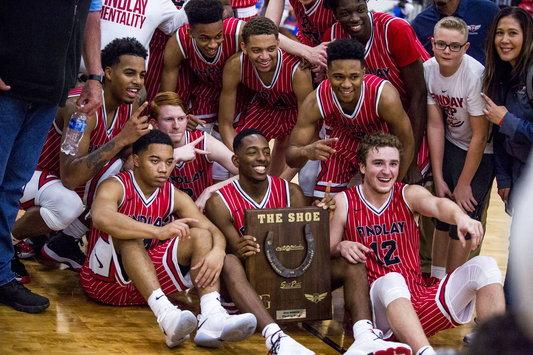 Findlay Prep players have their photo taken with "The Shoe" award after winning th ...