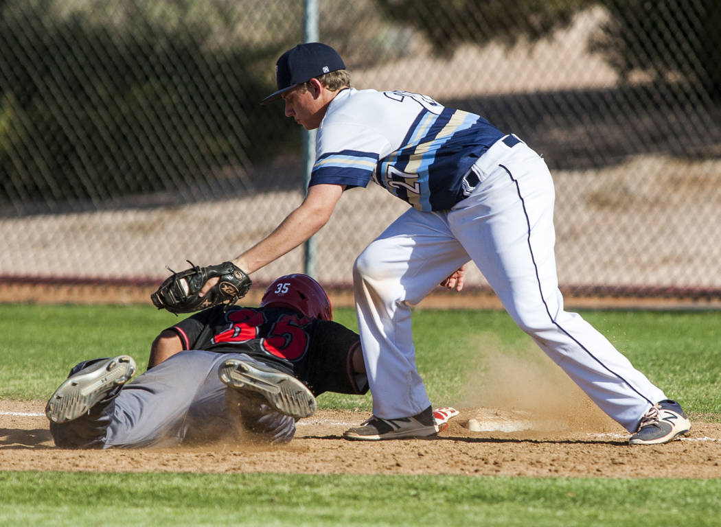 Las Vegas catcher Daniel Jimenez slides in safe at first while Foothill first baseman Tyler ...