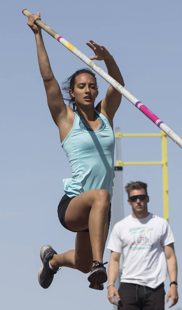 Gabby Carson, left, one of Nevada’s top prep pole vaulters, works on her technique dur ...