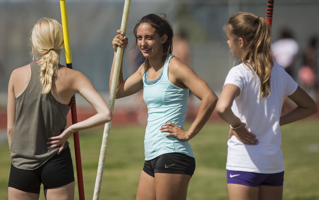 Gabby Carson, middle, one of Nevada’s top prep pole vaulters, talks with teammates dur ...