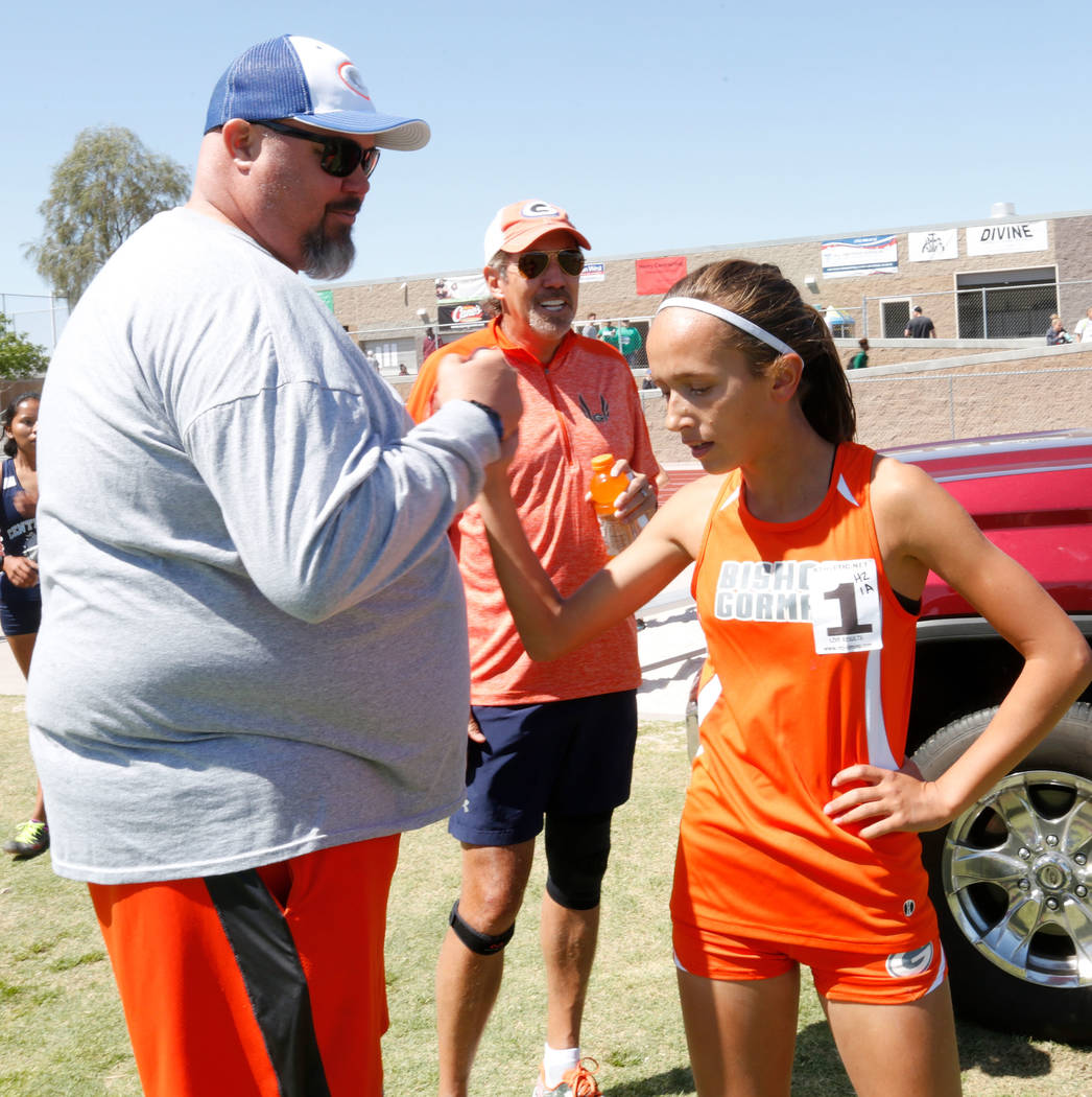 Bishop Gorman freshman Emilia Puskas (1) high fives Head Coach Scott Cooley after winning in ...